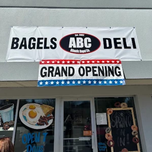 Atlantic Bagel Co. storefront with "BAGELS ABC DELI" and "GRAND OPENING" banners.